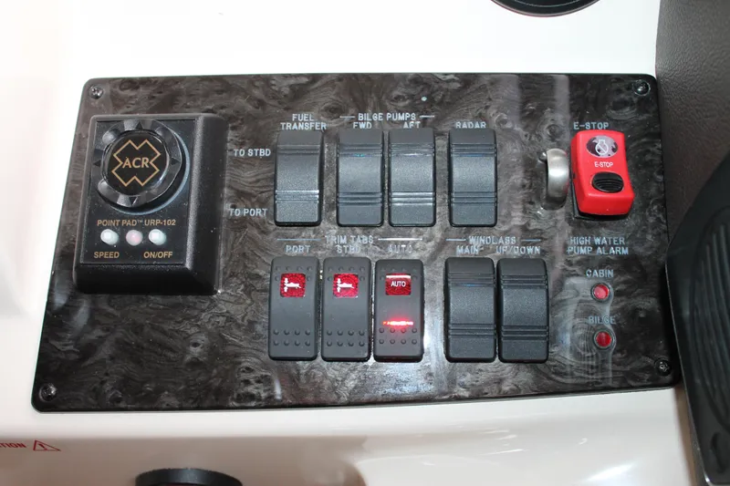 Slide: The Image of Control panel of a 2015 Sea Ray 470 Sundancer boat with various switches and buttons. - 118