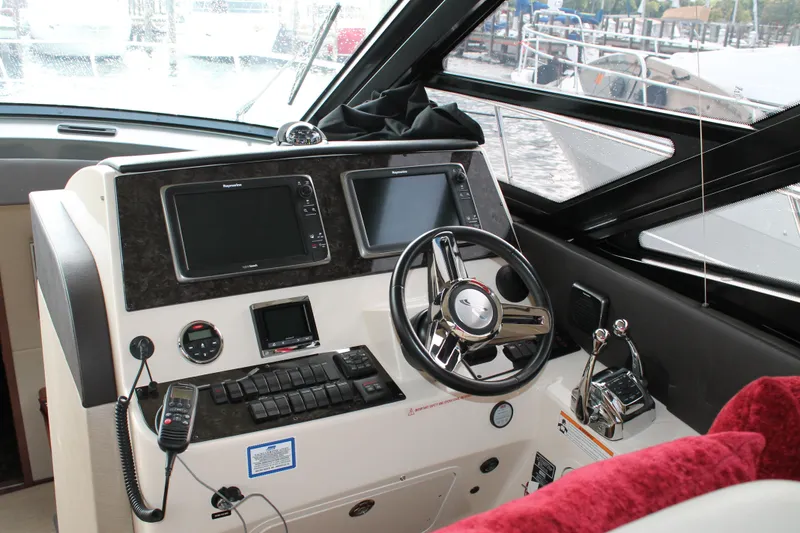 Slide: The Image of Helm of 2015 Sea Ray 470 Sundancer with modern navigation controls and steering wheel. - 125