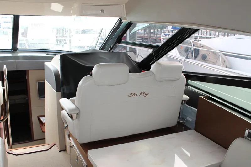 Slide: The Image of Interior of 2015 Sea Ray 470 Sundancer yacht with white seating and helm station. - 128