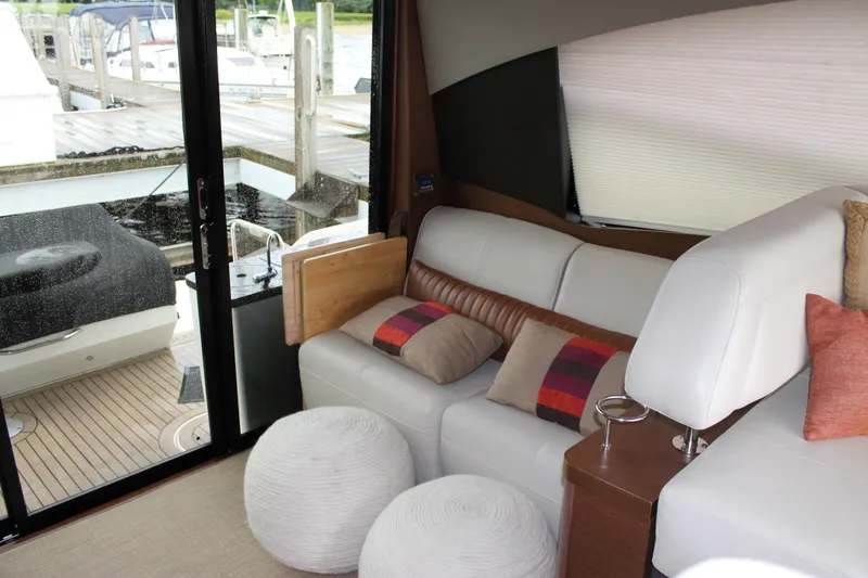 Slide: The Image of Interior of 2015 Sea Ray 470 Sundancer yacht with plush seating and decorative pillows. - 134