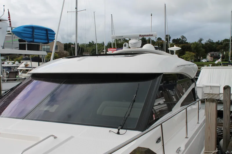 Slide: The Image of 2015 Sea Ray 470 Sundancer yacht docked at marina, featuring sleek design and modern equipment. - 136