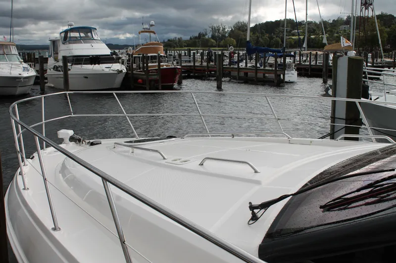 Slide: The Image of 2015 Sea Ray 470 Sundancer docked at a marina under cloudy skies. - 137