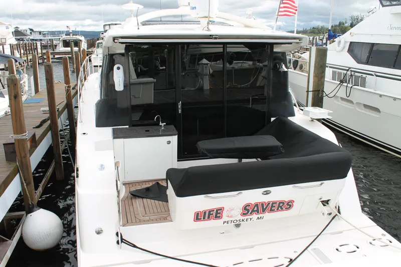 Slide: The Image of 2015 Sea Ray 470 Sundancer yacht docked, rear view with seating area, Petoskey, MI. - 138