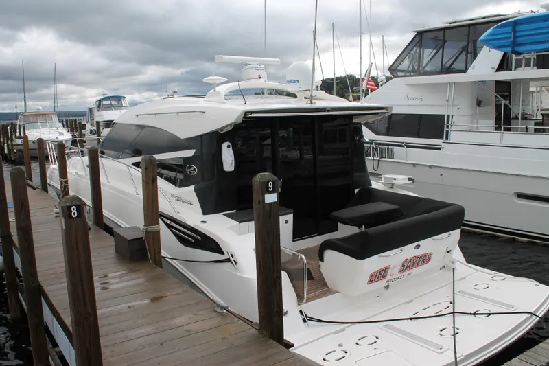 Slide: The Image of 2015 Sea Ray 470 Sundancer yacht docked at marina under cloudy skies. - 139