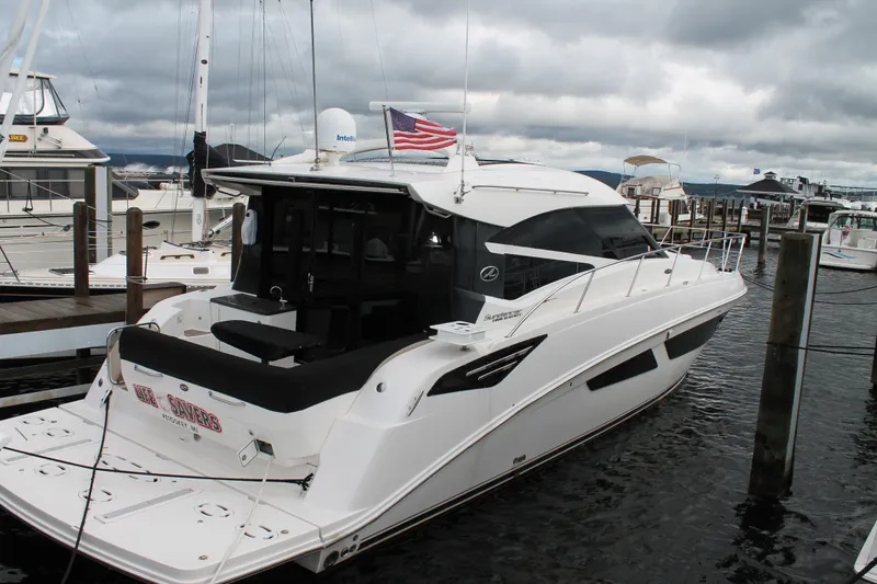 Slide: The Image of 2015 Sea Ray 470 Sundancer yacht docked at marina under cloudy skies. - 140