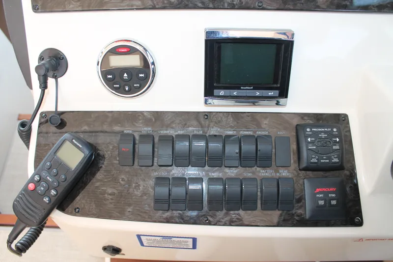 Slide: The Image of Control panel of 2015 Sea Ray 470 Sundancer with switches and navigation equipment. - 18