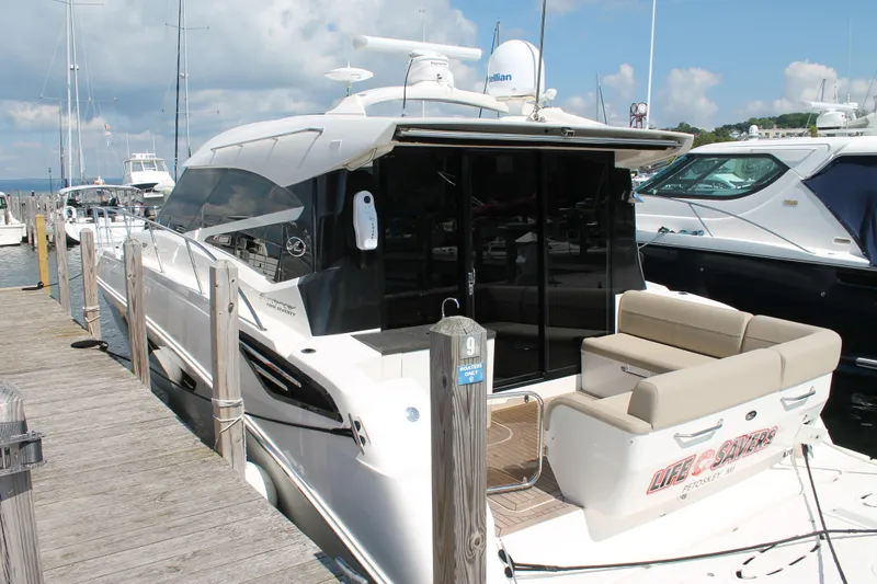 Slide: The Image of 2015 Sea Ray 470 Sundancer yacht docked at marina under blue sky. - 2
