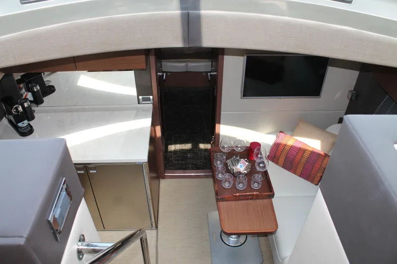 Slide: The Image of Interior of 2015 Sea Ray 470 Sundancer yacht with modern furnishings and dining area. - 29