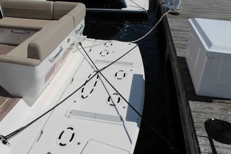 Slide: The Image of 2015 Sea Ray 470 Sundancer swim platform with seating, docked at marina. - 3