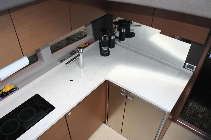 Slide: The Image of Modern kitchen area in 2015 Sea Ray 470 Sundancer yacht with sleek countertops and appliances. - 31