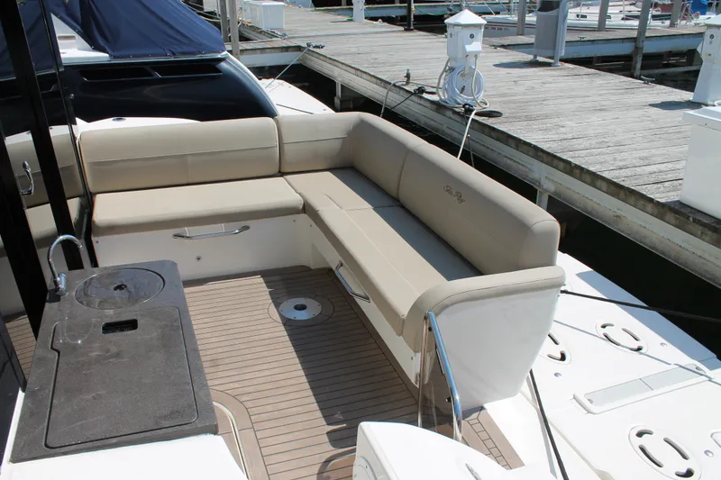 Slide: The Image of 2015 Sea Ray 470 Sundancer yacht with beige seating and deck at marina. - 4