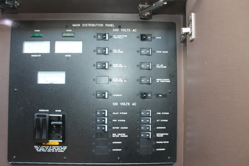 Slide: The Image of Main distribution panel of 2015 Sea Ray 470 Sundancer yacht, featuring 240V and 120V AC controls. - 42