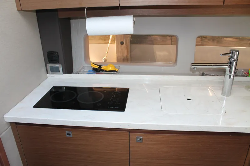 Slide: The Image of Modern kitchen area in a 2015 Sea Ray 470 Sundancer yacht with stovetop and sink. - 44