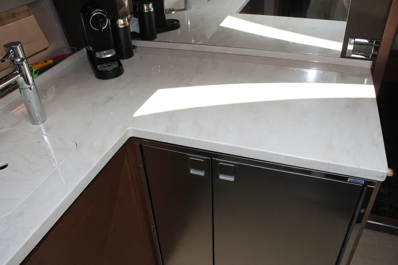 Slide: The Image of Modern kitchen countertop on 2015 Sea Ray 470 Sundancer yacht, featuring sleek design and appliances. - 45