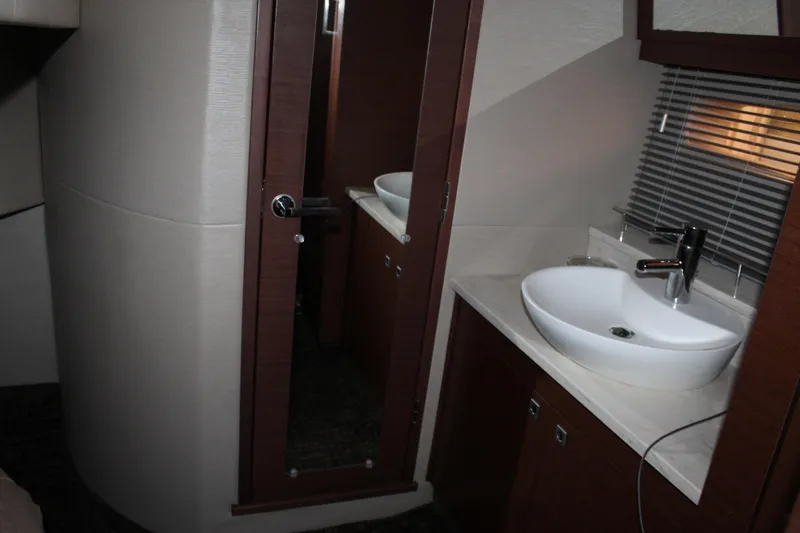 Slide: The Image of 2015 Sea Ray 470 Sundancer bathroom with modern sink and mirror. - 46