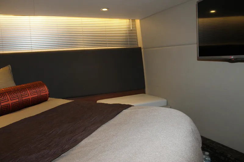 Slide: The Image of Interior of 2015 Sea Ray 470 Sundancer yacht, featuring a cozy bedroom with modern decor. - 49