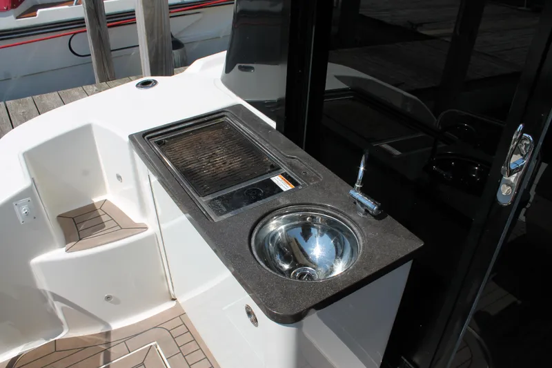 Slide: The Image of 2015 Sea Ray 470 Sundancer yacht kitchenette with sink and grill. - 5