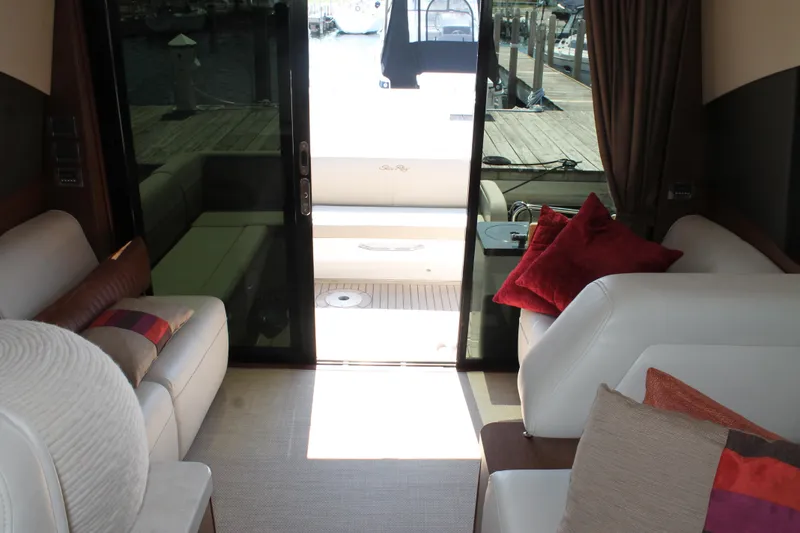 Slide: The Image of Interior of 2015 Sea Ray 470 Sundancer yacht with plush seating and decorative pillows. - 8