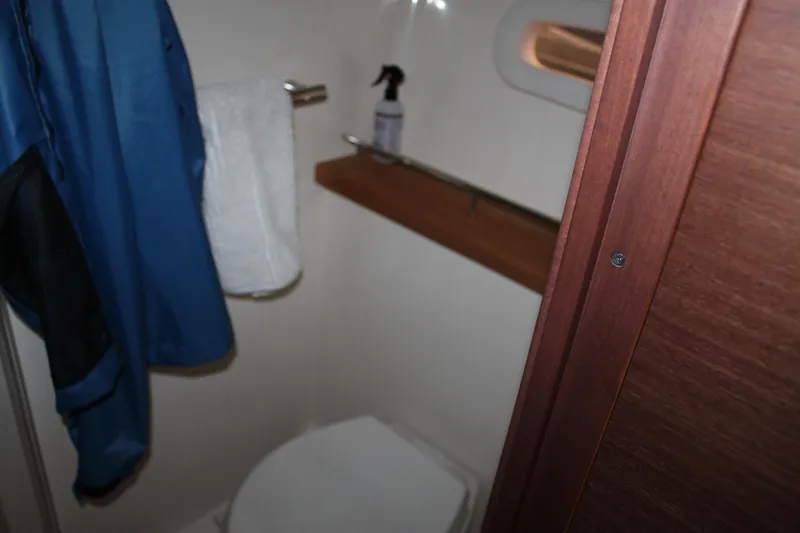 Slide: The Image of Bathroom interior of 2015 Sea Ray 470 Sundancer yacht, featuring towel and cleaning supplies. - 94