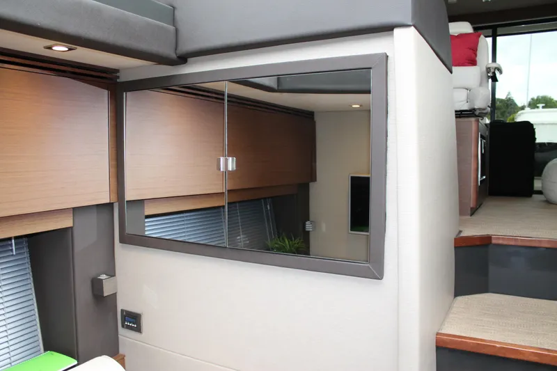 Slide: The Image of Interior of 2015 Sea Ray 470 Sundancer yacht with modern design and wooden accents. - 95