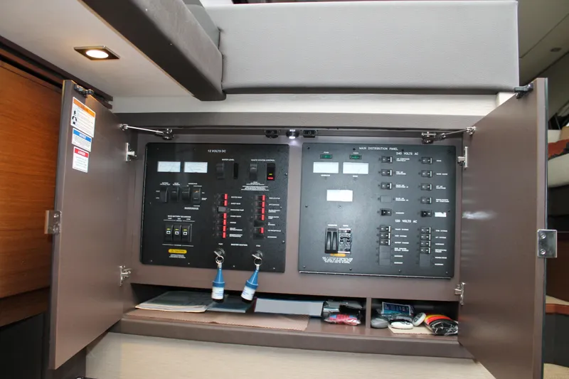 Slide: The Image of Electrical control panel inside 2015 Sea Ray 470 Sundancer yacht, featuring switches and meters. - 96