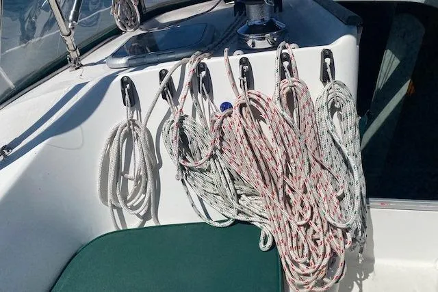 Slide: The Image of Ropes neatly coiled on a 2003 Beneteau Oceanis Clipper 361 sailboat deck. - 13