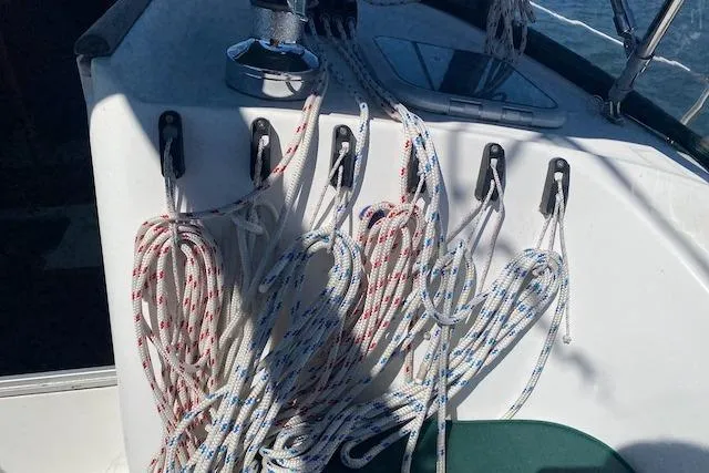 Slide: The Image of Ropes and cleats on a 2003 Beneteau Oceanis Clipper 361 sailboat deck. - 14