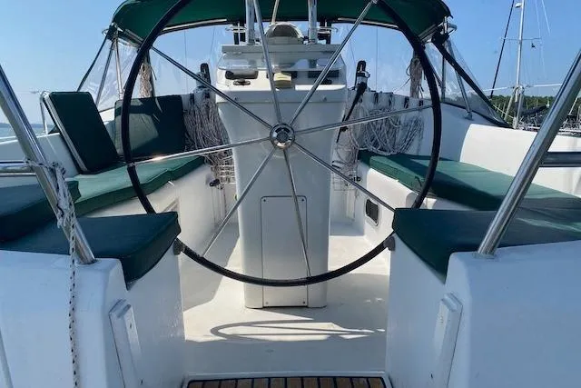 Slide: The Image of 2003 Beneteau Oceanis Clipper 361 sailboat cockpit with green seating and steering wheel. - 16