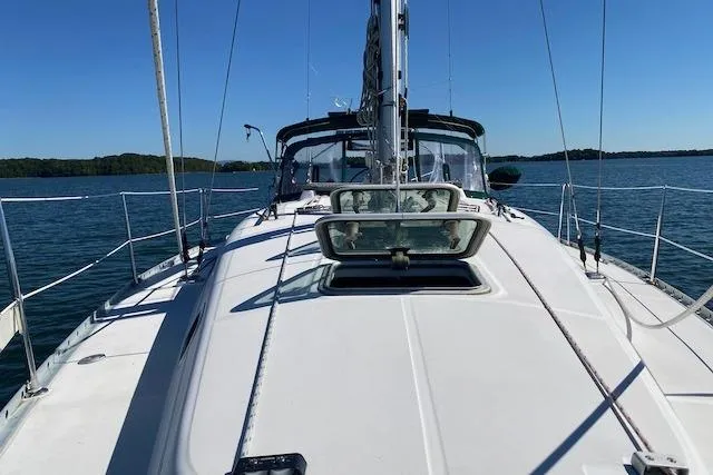 Slide: The Image of 2003 Beneteau Oceanis Clipper 361 sailboat on calm water, clear sky. - 2