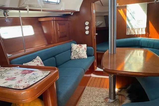 Slide: The Image of Interior of 2003 Beneteau Oceanis Clipper 361 yacht with blue seating and wooden finishes. - 26