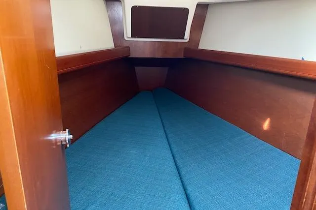 Slide: The Image of Interior cabin of 2003 Beneteau Oceanis Clipper 361 with blue cushions and wooden finish. - 29