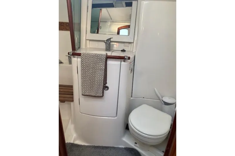 Slide: The Image of Bathroom interior of 2003 Beneteau Oceanis Clipper 361 yacht, featuring sink and toilet. - 32