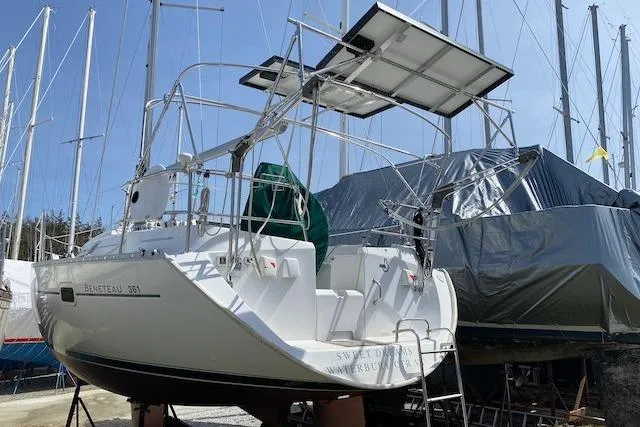 Slide: The Image of 2003 Beneteau Oceanis Clipper 361 sailboat on dry dock, featuring solar panels and sleek design. - 34