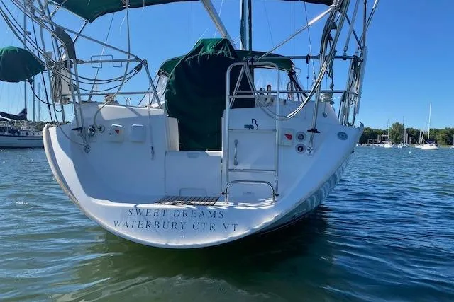 Slide: The Image of 2003 Beneteau Oceanis Clipper 361 sailboat docked on calm water. - 4