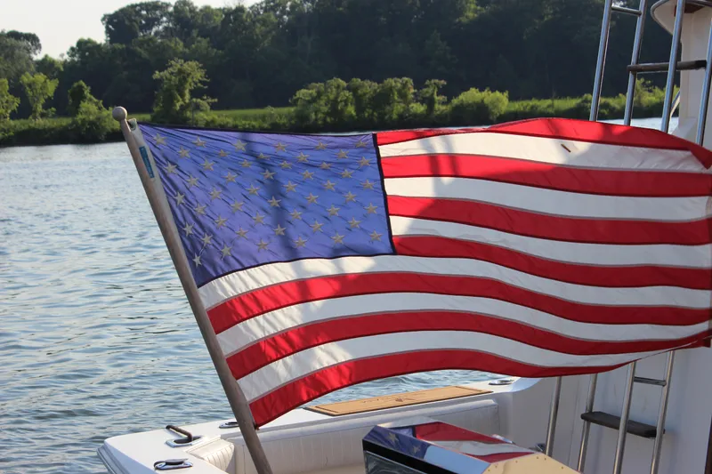 Slide: The Image of American flag on a 1988 Bertram 33II Flybridge Cruiser boat. - 10