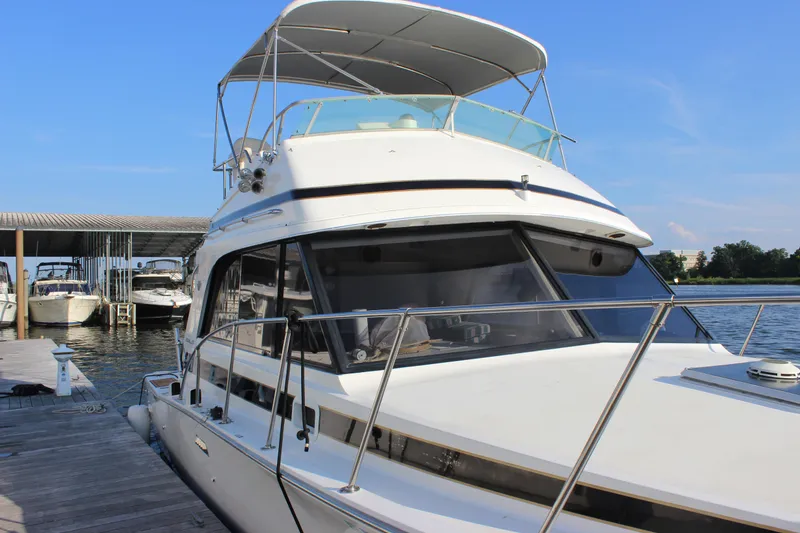 Slide: The Image of 1988 Bertram 33II Flybridge Cruiser docked at marina. - 23