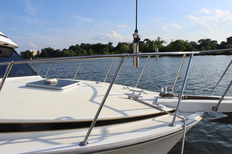 Slide: The Image of 1988 Bertram 33II Flybridge Cruiser on calm water with clear sky. - 24