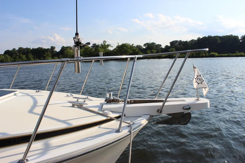 Slide: The Image of 1988 Bertram 33II Flybridge Cruiser on calm water with scenic background. - 25