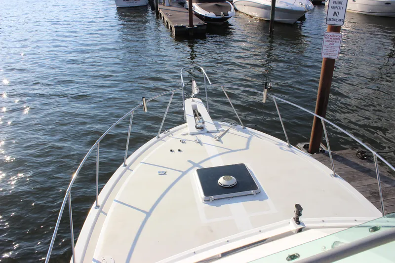 Slide: The Image of 1988 Bertram 33II Flybridge Cruiser bow view at dock. - 29