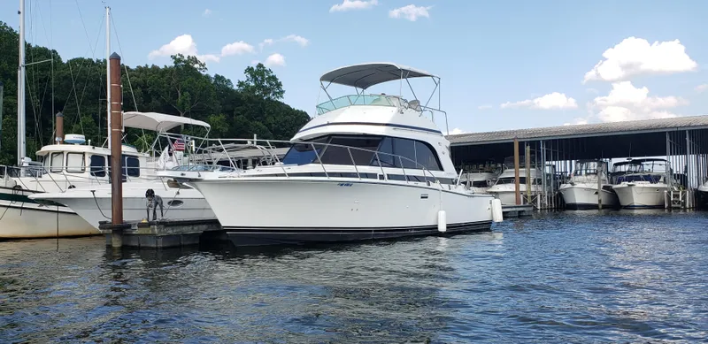 Slide: The Image of 1988 Bertram 33II Flybridge Cruiser docked at a marina on a sunny day. - 3