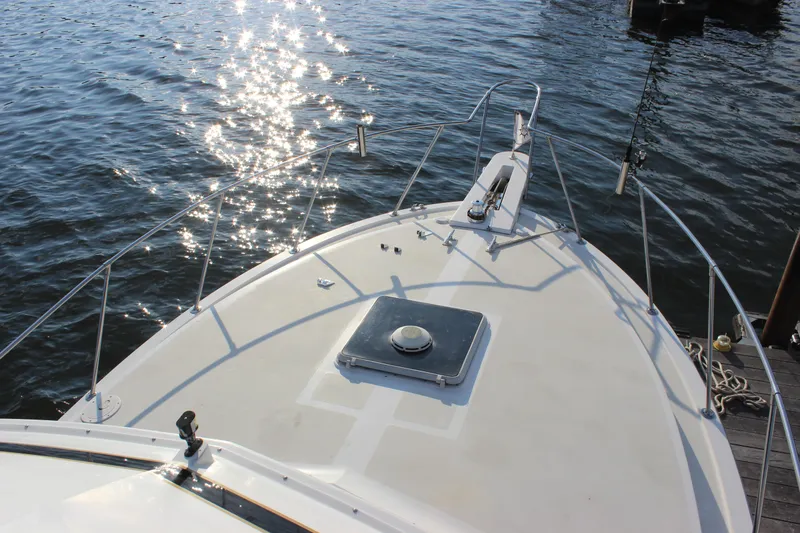 Slide: The Image of 1988 Bertram 33II Flybridge Cruiser bow view on water. - 30