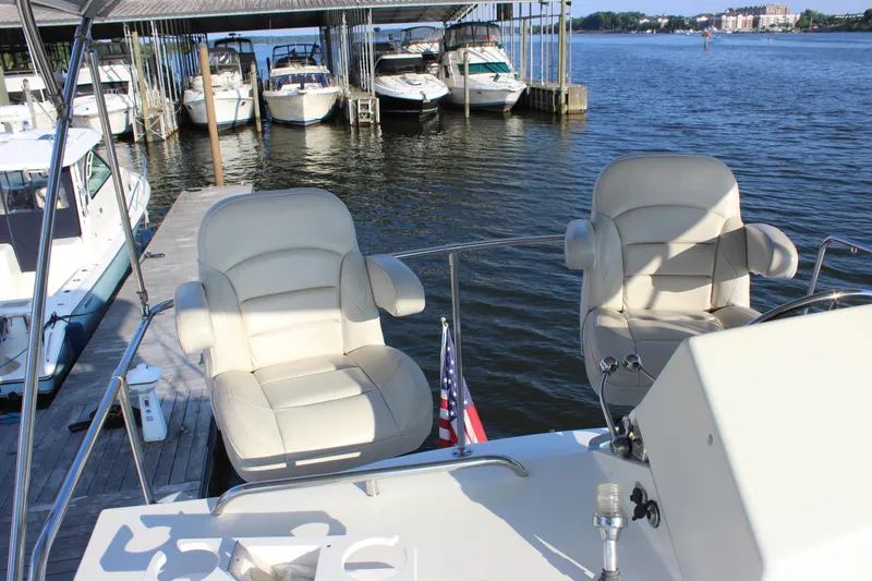 Slide: The Image of 1988 Bertram 33II Flybridge Cruiser at dock with two captain's chairs. - 31