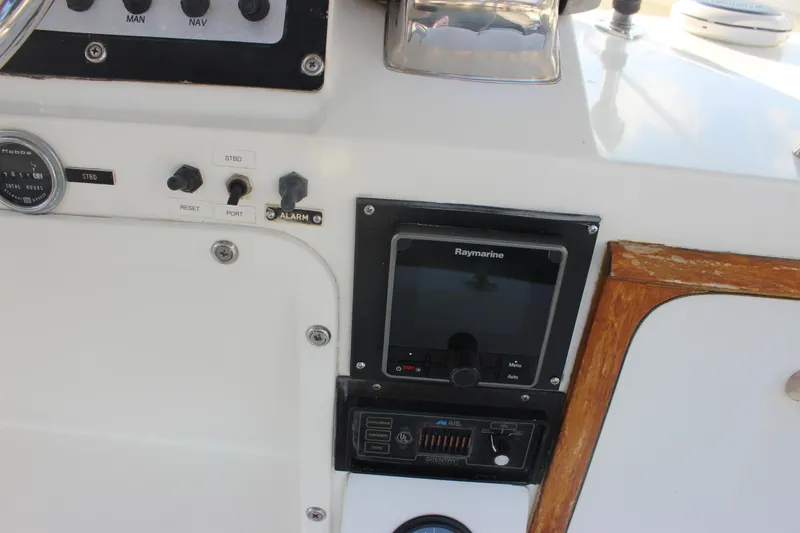 Slide: The Image of 1988 Bertram 33II Flybridge Cruiser dashboard with Raymarine navigation system. - 33