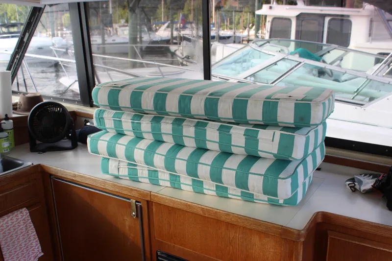 Slide: The Image of Stacked cushions inside a 1988 Bertram 33II Flybridge Cruiser. - 45