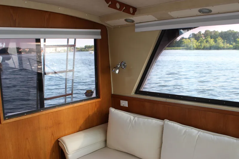 Slide: The Image of Interior of 1988 Bertram 33II Flybridge Cruiser with lake view through windows. - 47