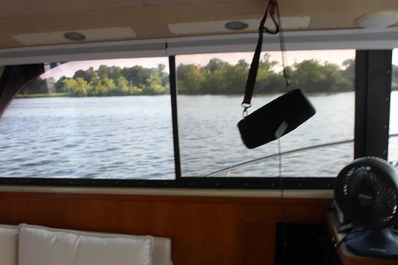Slide: The Image of Interior view of 1988 Bertram 33II Flybridge Cruiser with river scenery. - 48