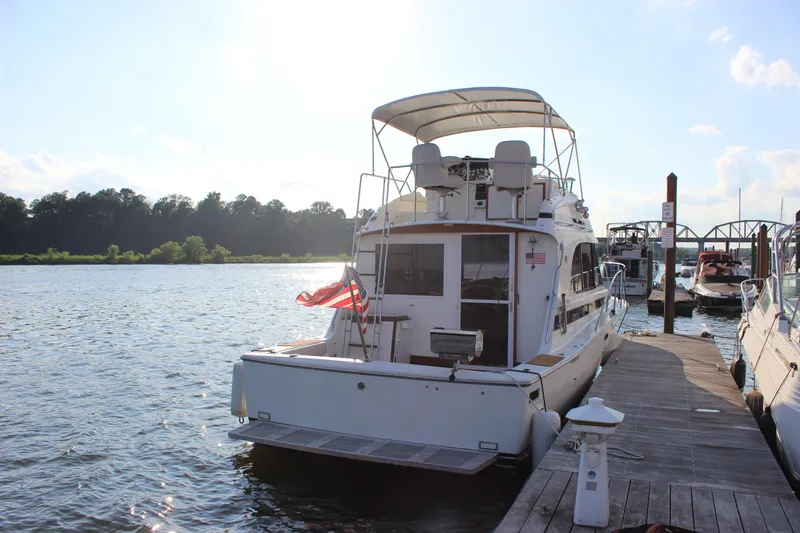 Slide: The Image of 1988 Bertram 33II Flybridge Cruiser docked at a marina on a sunny day. - 6
