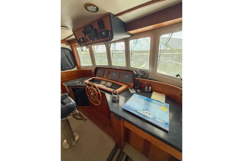 Slide: The Image of 2007 Nordic Tug 54 docked in a covered marina, side view. - 18