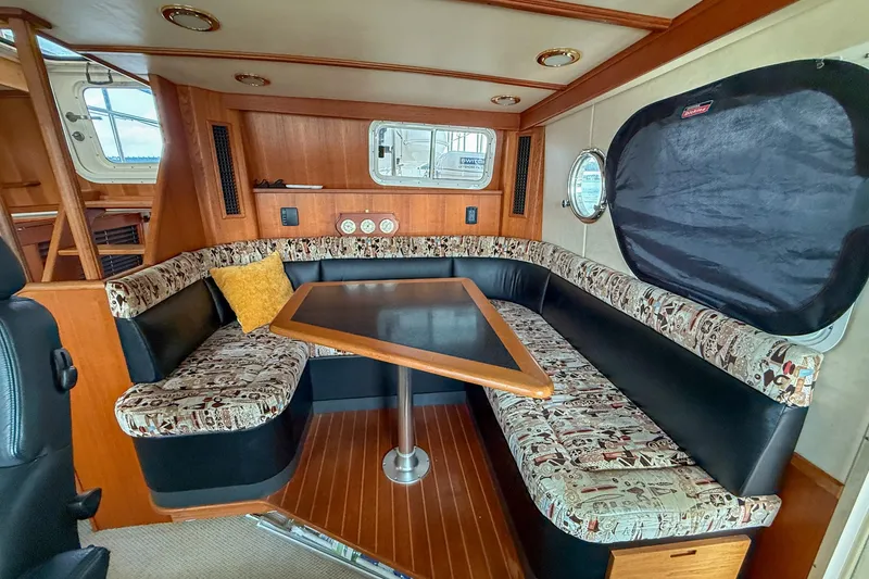 Slide: The Image of 2007 Nordic Tug 54 docked under a covered marina, side view. - 19