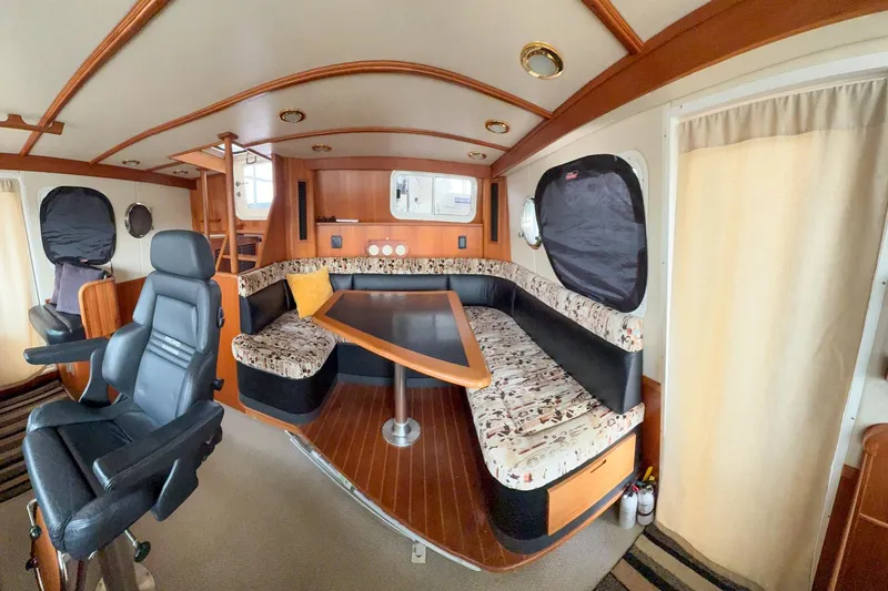 Slide: The Image of 2007 Nordic Tug 54 docked in a covered marina, side view. - 20